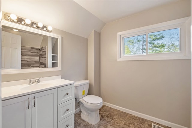 full bath featuring vanity, baseboards, vaulted ceiling, toilet, and a shower