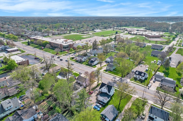 aerial view of property and surrounding area with nearby suburban area