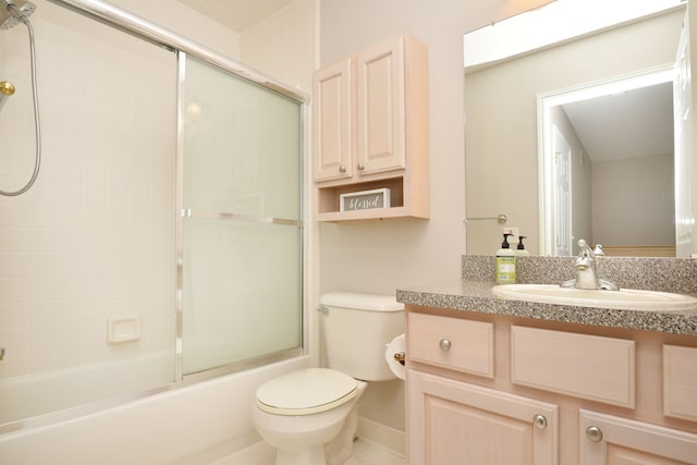 bathroom featuring toilet, vanity, and bath / shower combo with glass door