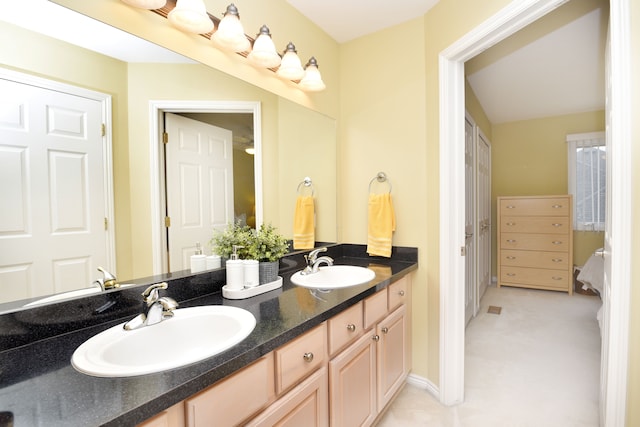 bathroom featuring a sink and double vanity