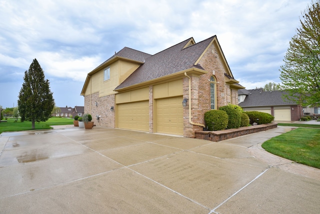 view of side of home featuring a shingled roof, concrete driveway, brick siding, and an attached garage