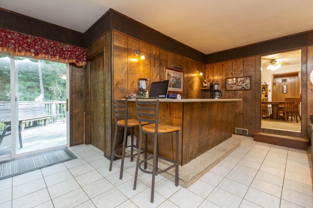 70765 Carter Ave, Niles, MI 49120 - bar with a dry bar, visible vents, ceiling fan, wooden walls, and light tile patterned floors