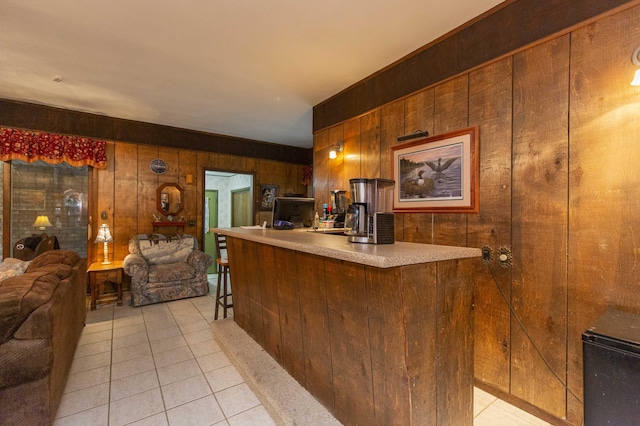 70765 Carter Ave, Niles, MI 49120 - kitchen with light tile patterned floors, a peninsula, wood walls, and open floor plan