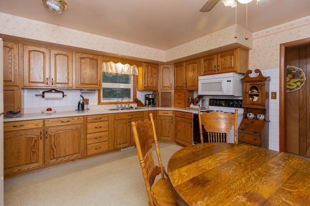 70765 Carter Ave, Niles, MI 49120 - kitchen featuring brown cabinets, a sink, wallpapered walls, range with electric cooktop, and white microwave