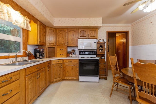 70765 Carter Ave, Niles, MI 49120 - kitchen featuring a sink, wallpapered walls, a wainscoted wall, electric range, and white microwave