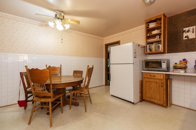 70765 Carter Ave, Niles, MI 49120 - dining room with wallpapered walls, a toaster, a wainscoted wall, tile walls, and ceiling fan
