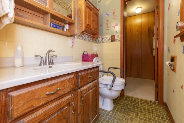 70765 Carter Ave, Niles, MI 49120 - bathroom with toilet, wallpapered walls, tile walls, wainscoting, and vanity
