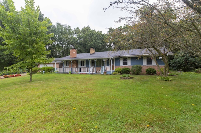 70765 Carter Ave, Niles, MI 49120 - view of front of home featuring a porch, brick siding, a front lawn, and a chimney