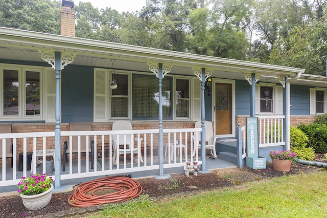 70765 Carter Ave, Niles, MI 49120 - view of front of property with covered porch, brick siding, a chimney, and stone siding