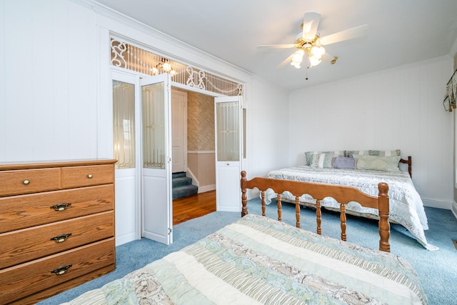 bedroom featuring ceiling fan, ornamental molding, and carpet floors