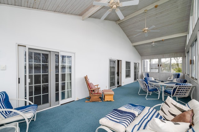 sunroom featuring carpet flooring, beam ceiling, and ceiling fan