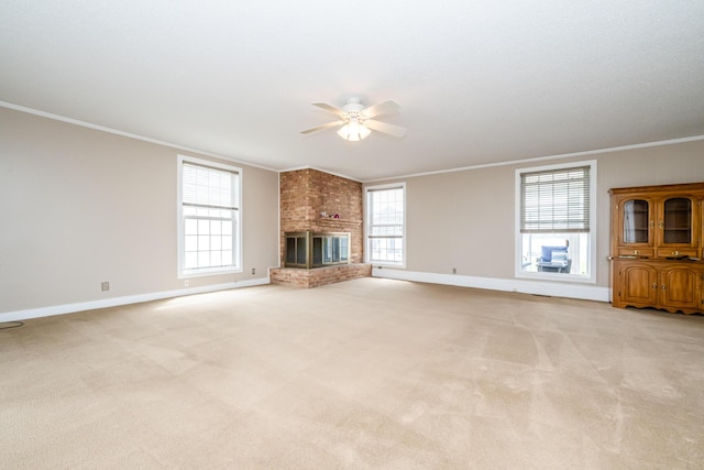 unfurnished living room with crown molding, light carpet, baseboards, and ceiling fan
