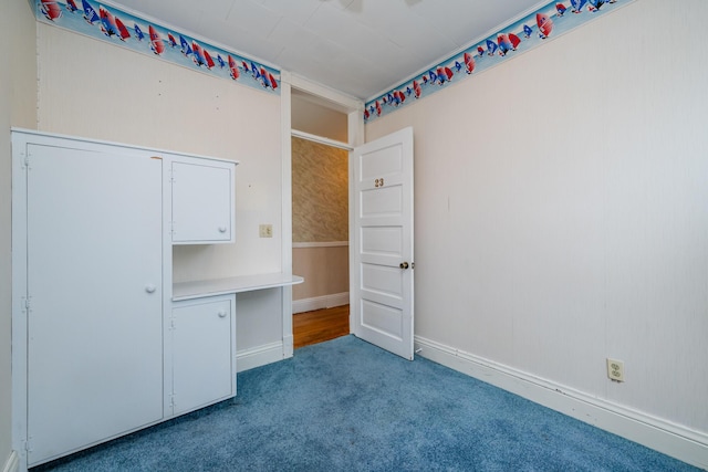 unfurnished bedroom with carpet floors and baseboards