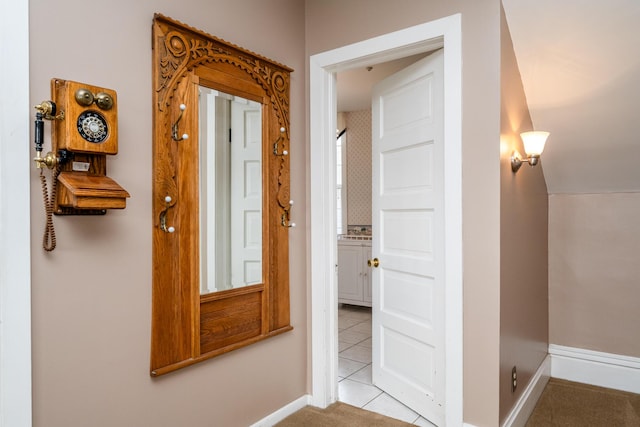 corridor with tile patterned floors and baseboards