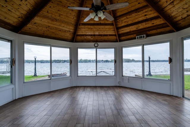 unfurnished sunroom featuring a water view, visible vents, and ceiling fan