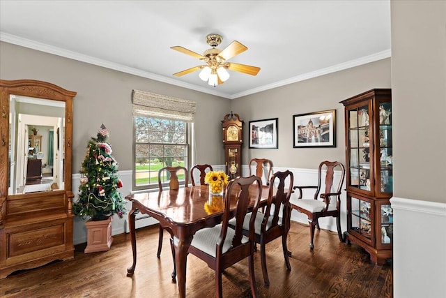 dining area with crown molding, wood finished floors, and a ceiling fan