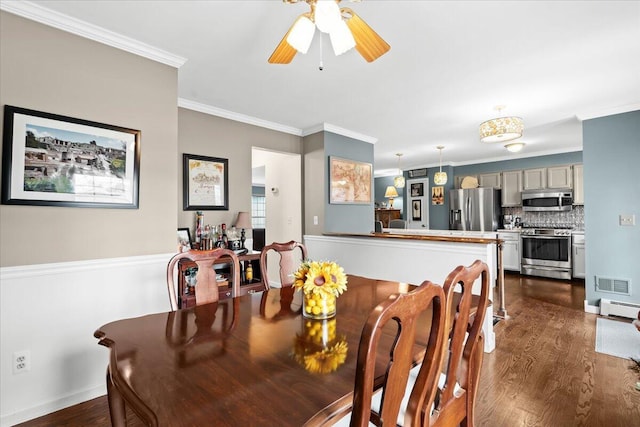 dining space with a baseboard radiator, ceiling fan, visible vents, crown molding, and dark wood-style floors
