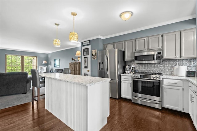 kitchen featuring light stone counters, dark wood finished floors, open floor plan, crown molding, and appliances with stainless steel finishes