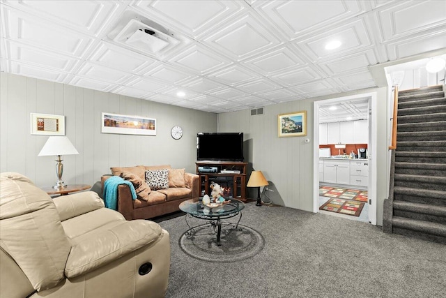 living room with stairway, carpet floors, an ornate ceiling, and visible vents