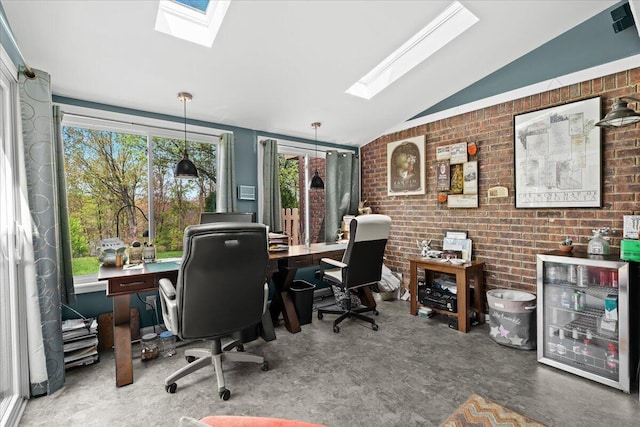office area featuring vaulted ceiling with skylight and brick wall