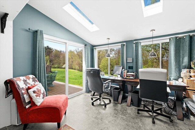 home office with lofted ceiling with skylight