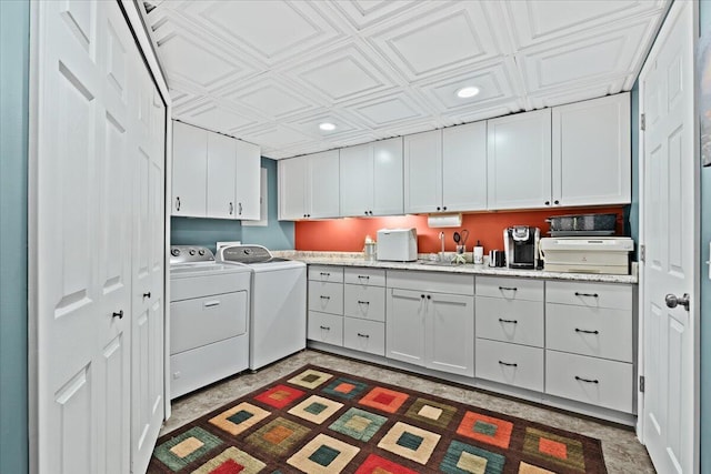 clothes washing area with washer and clothes dryer, a sink, an ornate ceiling, and recessed lighting