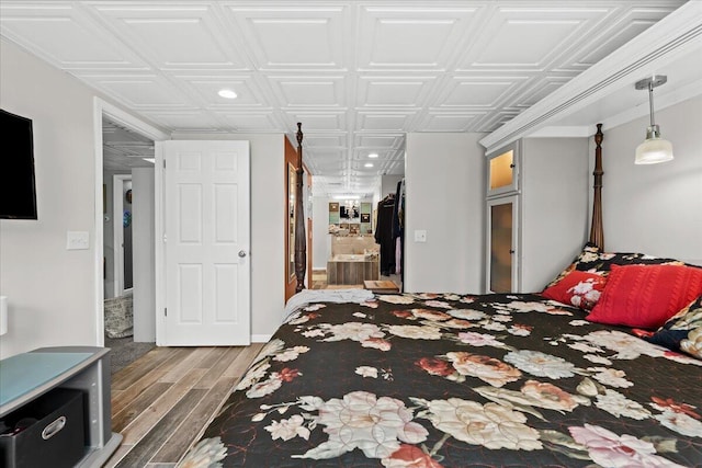 bedroom featuring an ornate ceiling, recessed lighting, and wood finished floors