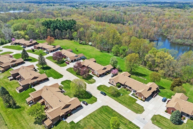 birds eye view of property with a water view, a residential view, and a wooded view