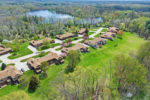bird's eye view featuring a wooded view, a water view, and a residential view