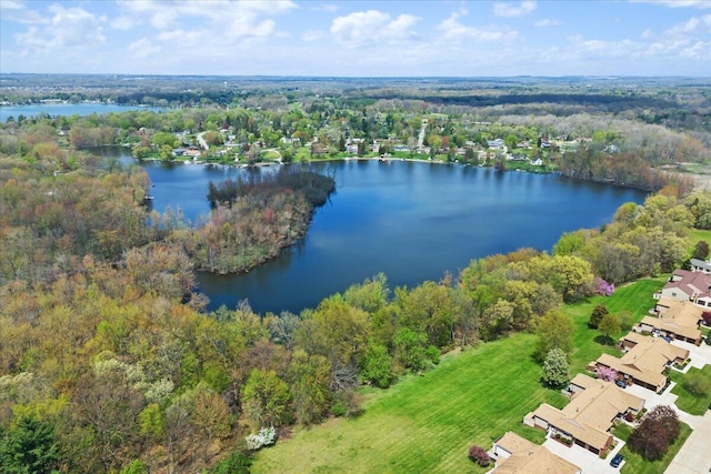 aerial view featuring a water view and a wooded view