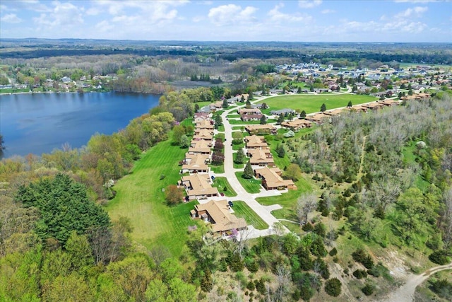 birds eye view of property with a water view, a view of trees, and a residential view
