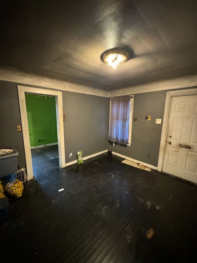 empty room with wood finished floors and baseboards