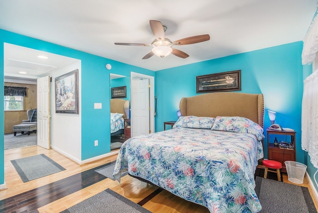 bedroom featuring ceiling fan, baseboards, and wood finished floors