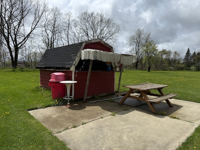 view of patio featuring an outbuilding and a storage unit