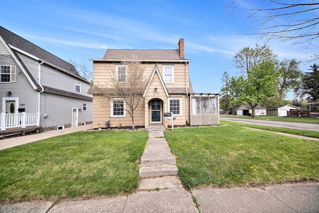 1009 S Webster St, Jackson, MI 49203 - traditional-style house with a chimney, a front yard, and entry steps