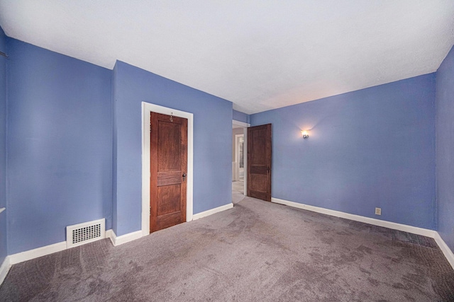 1009 S Webster St, Jackson, MI 49203 - carpeted spare room featuring baseboards