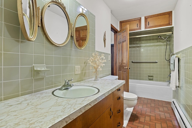 bathroom featuring toilet, tile walls, a baseboard heating unit, brick floor, and vanity