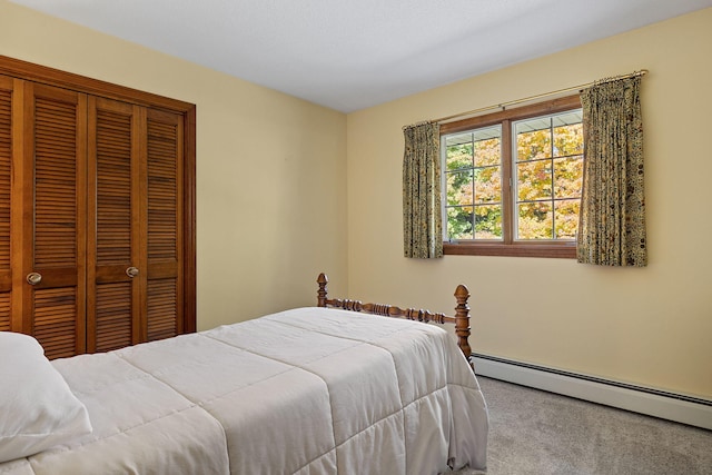 carpeted bedroom with a closet and baseboard heating