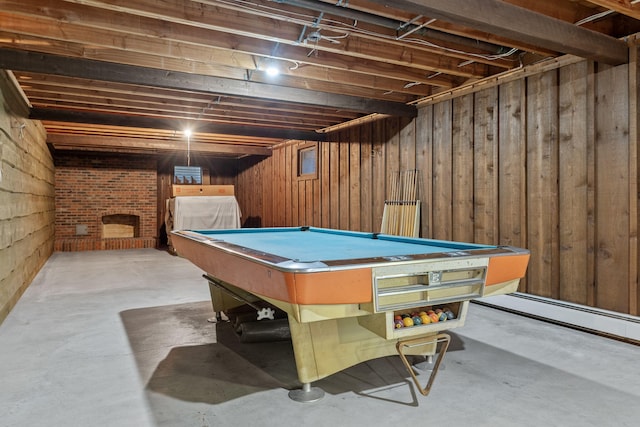 recreation room featuring wooden walls, pool table, baseboard heating, and concrete floors