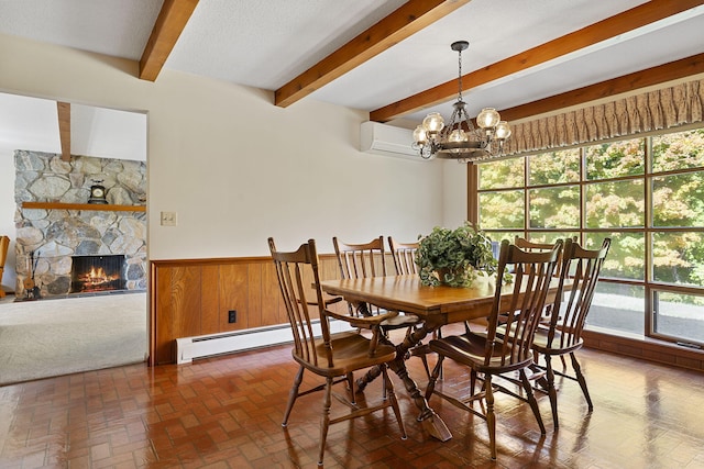 dining space with a baseboard radiator, beamed ceiling, a wall unit AC, wainscoting, and a notable chandelier