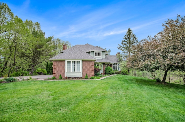 5401 Lone Pine Ct, Brighton, MI 48116 - rear view of house featuring a chimney, brick siding, a yard, and a shingled roof