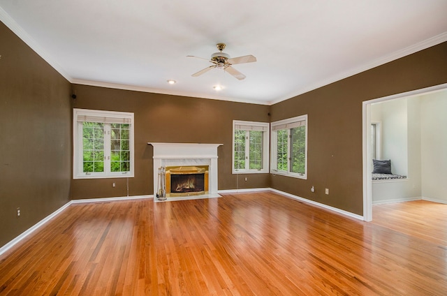 5401 Lone Pine Ct, Brighton, MI 48116 - unfurnished living room with light wood-type flooring, ceiling fan, baseboards, a fireplace, and ornamental molding