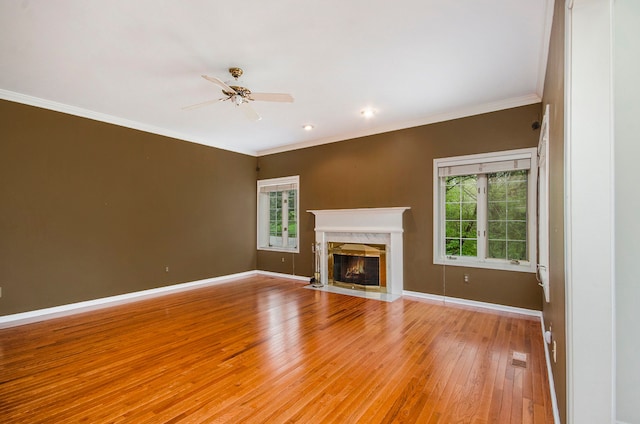 5401 Lone Pine Ct, Brighton, MI 48116 - unfurnished living room featuring light wood-style flooring, a ceiling fan, a fireplace, ornamental molding, and baseboards