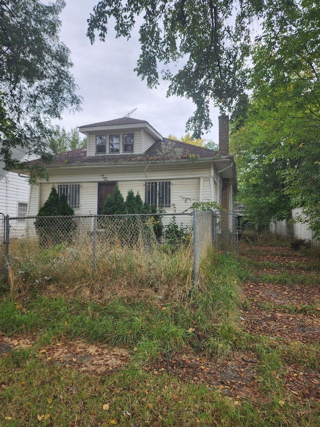 view of front of home featuring fence and a chimney