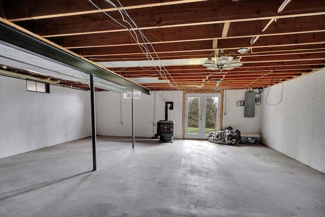 basement featuring a wood stove and electric panel