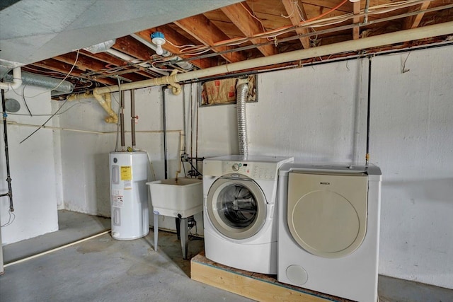laundry area featuring a sink, electric water heater, laundry area, and separate washer and dryer