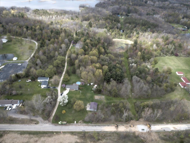 birds eye view of property with a water view and a view of trees