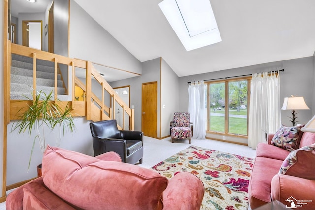 living area with a skylight, stairway, carpet floors, and high vaulted ceiling