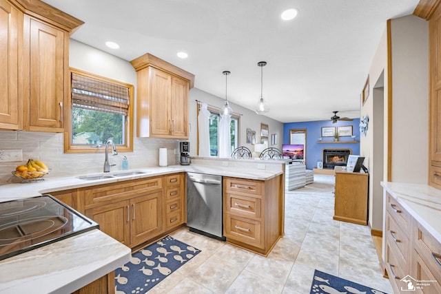 kitchen featuring a warm lit fireplace, stainless steel dishwasher, a sink, open floor plan, and a peninsula
