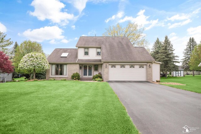 traditional-style house featuring a front lawn, brick siding, driveway, and a garage